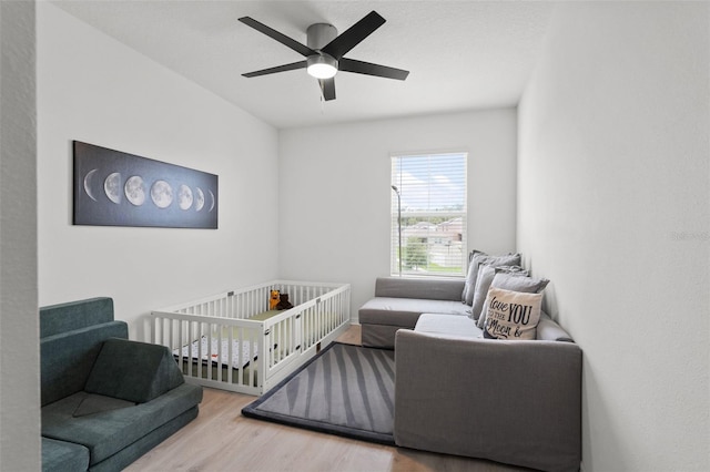 10823 Trailing Vine Dr, Tampa, FL 33610 - bedroom featuring wood finished floors, a nursery area, and a ceiling fan