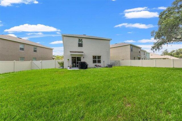 10823 Trailing Vine Dr, Tampa, FL 33610 - rear view of property featuring stucco siding and a fenced backyard
