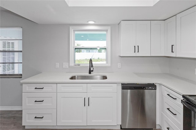 7322 Ellis Ln, Port Charlotte, FL 33981 - kitchen with stainless steel dishwasher, white cabinets, healthy amount of natural light, and light countertops