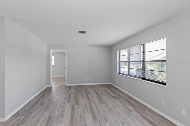 7322 Ellis Ln, Port Charlotte, FL 33981 - empty room with light wood-style flooring and baseboards