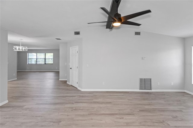 7322 Ellis Ln, Port Charlotte, FL 33981 - spare room featuring a chandelier, light wood finished floors, a ceiling fan, and lofted ceiling