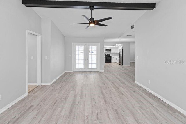7322 Ellis Ln, Port Charlotte, FL 33981 - unfurnished living room featuring ceiling fan, light wood finished floors, french doors, and a chandelier