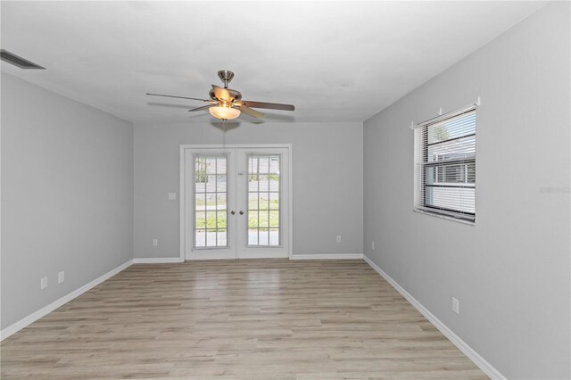 7322 Ellis Ln, Port Charlotte, FL 33981 - empty room with french doors, a ceiling fan, and light wood-type flooring