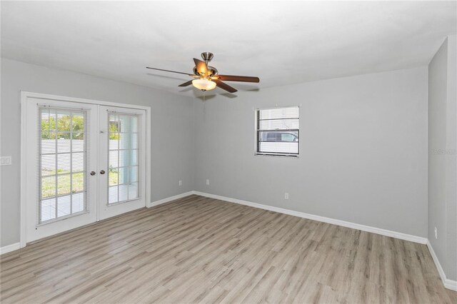 7322 Ellis Ln, Port Charlotte, FL 33981 - empty room featuring french doors, light wood-type flooring, and a ceiling fan