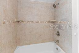 7322 Ellis Ln, Port Charlotte, FL 33981 - bathroom featuring washtub / shower combination