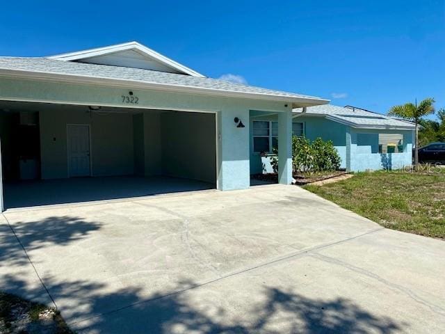 7322 Ellis Ln, Port Charlotte, FL 33981 - view of front of house featuring concrete driveway, an attached garage, and stucco siding