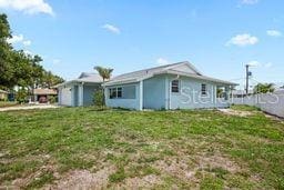 7322 Ellis Ln, Port Charlotte, FL 33981 - rear view of house with a yard