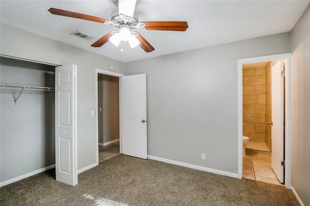 310 SW 76th Ter, North Lauderdale, FL 33068 - unfurnished bedroom featuring carpet flooring, a closet, tile patterned floors, ensuite bath, and ceiling fan