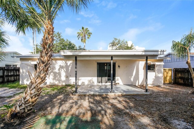 310 SW 76th Ter, North Lauderdale, FL 33068 - back of property featuring stucco siding and a patio area