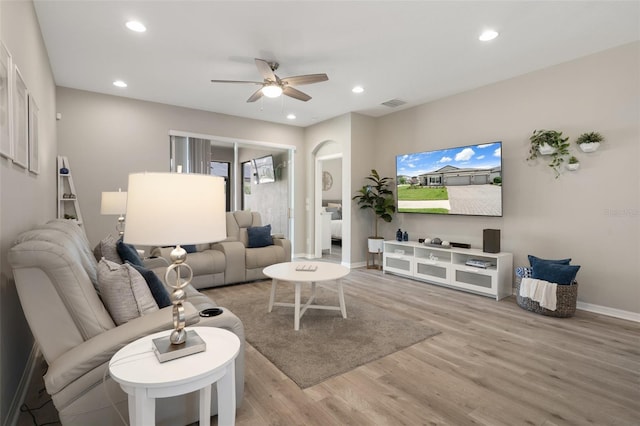 20108 Stone Pine Cir, Lutz, FL 33558 - living room featuring a ceiling fan, light wood finished floors, recessed lighting, and arched walkways