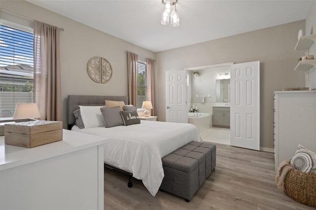 20108 Stone Pine Cir, Lutz, FL 33558 - bedroom with light wood finished floors and ensuite bathroom