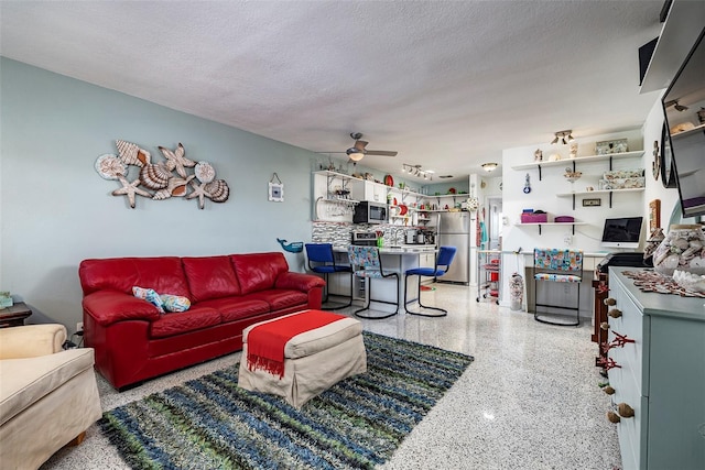 505 67th Ave Unit 11, St Pete Beach, FL 33706 - living room with dark aggregate flooring, a textured ceiling, and a ceiling fan