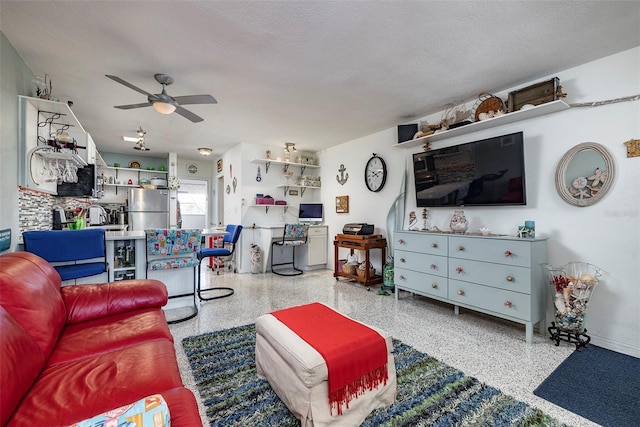 505 67th Ave Unit 11, St Pete Beach, FL 33706 - living area featuring speckled floor, a ceiling fan, and a textured ceiling