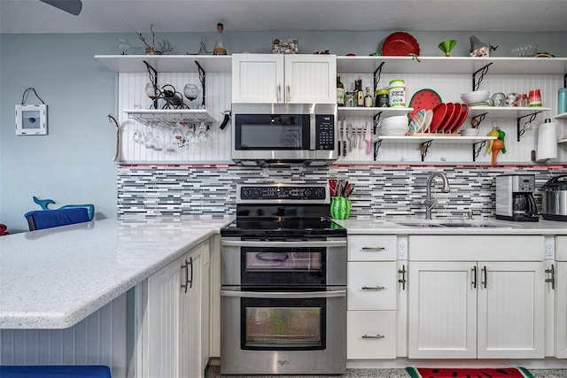 505 67th Ave Unit 11, St Pete Beach, FL 33706 - kitchen featuring open shelves, stainless steel appliances, decorative backsplash, and white cabinets