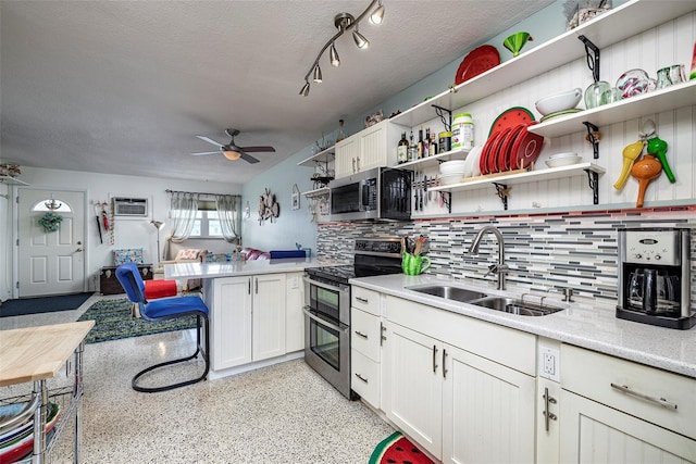505 67th Ave Unit 11, St Pete Beach, FL 33706 - kitchen with stainless steel appliances, open shelves, a peninsula, ceiling fan, and backsplash