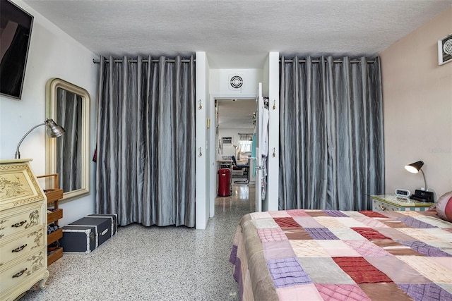 505 67th Ave Unit 11, St Pete Beach, FL 33706 - bedroom with dark speckled floor and a textured ceiling