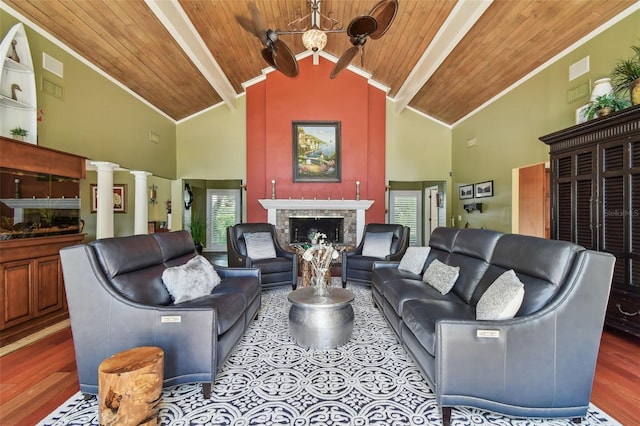 16205 Sentry Woods Ct, Odessa, FL 33556 - living room with a fireplace with raised hearth, a wood ceiling with exposed beams, wood finished floors, ornate columns, and a chandelier