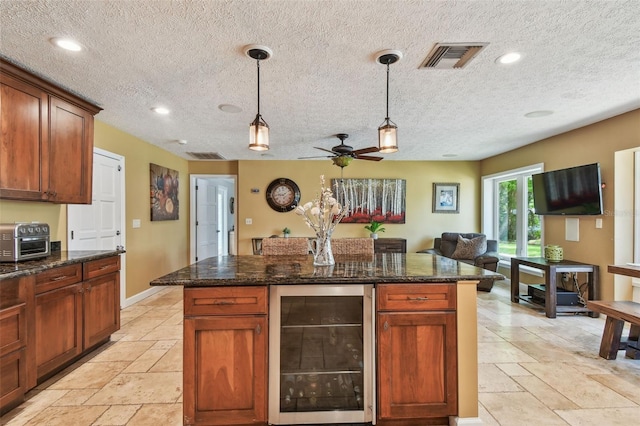 16205 Sentry Woods Ct, Odessa, FL 33556 - kitchen featuring wine cooler, stone tile floors, hanging light fixtures, recessed lighting, and a textured ceiling