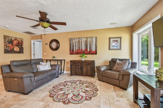 16205 Sentry Woods Ct, Odessa, FL 33556 - living room featuring a textured ceiling, ceiling fan, and light stone finish floors
