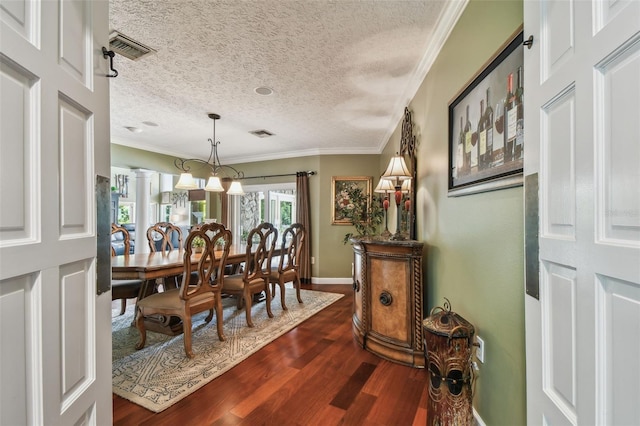 16205 Sentry Woods Ct, Odessa, FL 33556 - dining area with a textured ceiling, dark wood finished floors, and ornamental molding