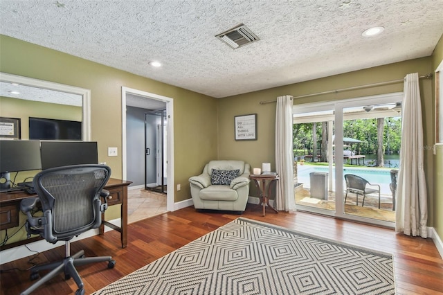 16205 Sentry Woods Ct, Odessa, FL 33556 - office space featuring wood finished floors, a textured ceiling, and recessed lighting