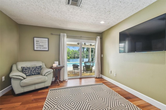16205 Sentry Woods Ct, Odessa, FL 33556 - living area with wood finished floors and a textured ceiling