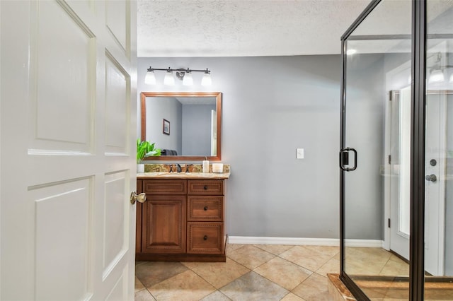 16205 Sentry Woods Ct, Odessa, FL 33556 - bathroom featuring vanity, tile patterned floors, a textured ceiling, and a shower stall