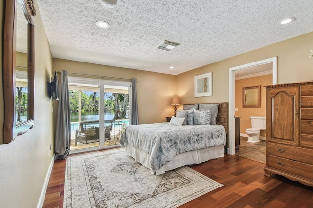 16205 Sentry Woods Ct, Odessa, FL 33556 - bedroom with access to exterior, a textured ceiling, connected bathroom, dark wood-style flooring, and recessed lighting