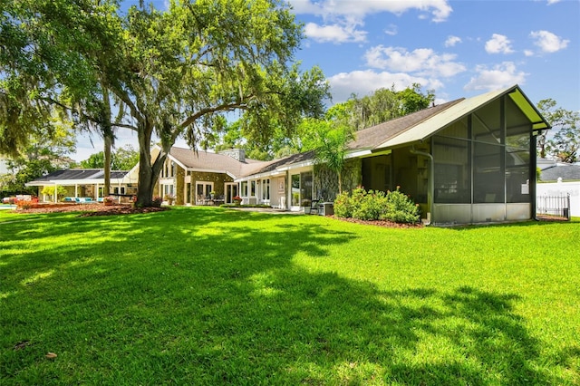 16205 Sentry Woods Ct, Odessa, FL 33556 - rear view of house featuring a lawn and a sunroom