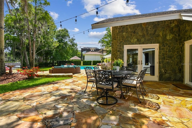 16205 Sentry Woods Ct, Odessa, FL 33556 - view of patio / terrace featuring french doors and outdoor dining area