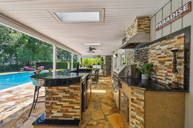 16205 Sentry Woods Ct, Odessa, FL 33556 - view of patio with exterior kitchen, an outdoor pool, and a ceiling fan