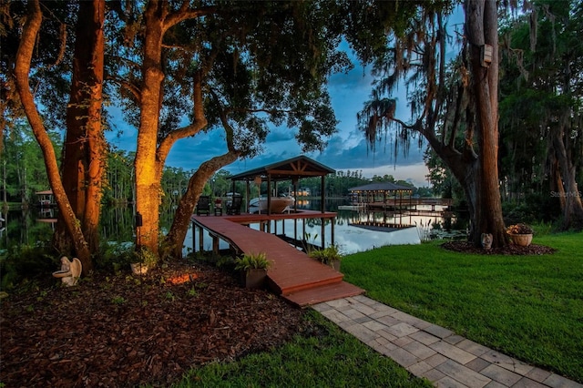 16205 Sentry Woods Ct, Odessa, FL 33556 - dock featuring boat lift, a lawn, and a water view