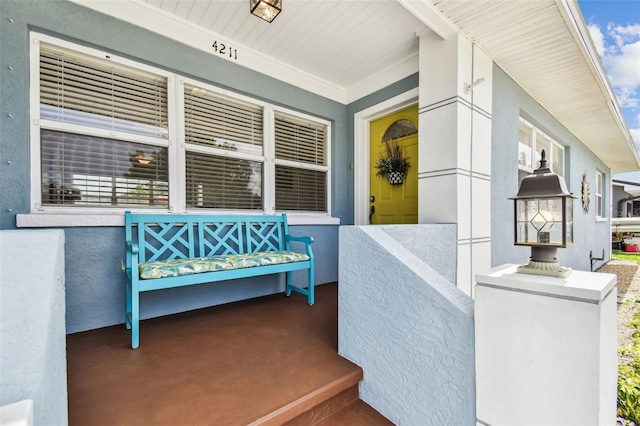 4211 28th Ave N, Saint Petersburg, FL 33713 - doorway to property with covered porch and stucco siding