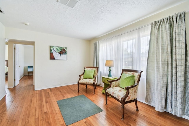 4211 28th Ave N, Saint Petersburg, FL 33713 - living area with light wood-style flooring and a textured ceiling