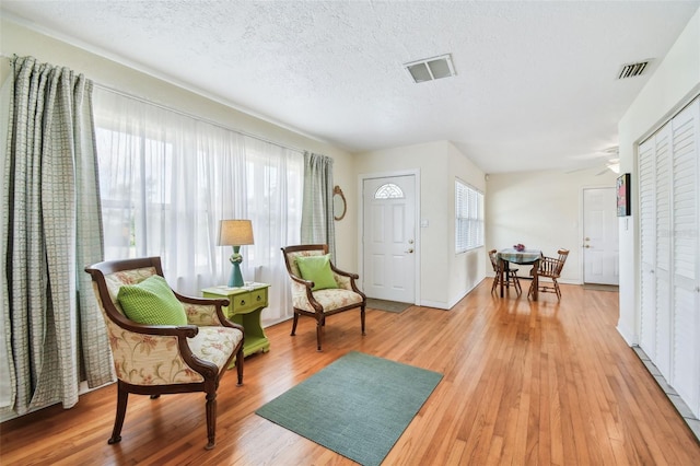 4211 28th Ave N, Saint Petersburg, FL 33713 - foyer with healthy amount of natural light, light wood-style flooring, and a textured ceiling