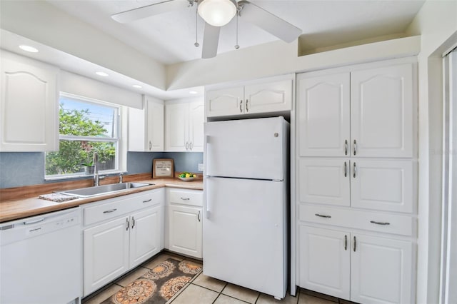 4211 28th Ave N, Saint Petersburg, FL 33713 - kitchen with white appliances, white cabinets, light tile patterned flooring, light countertops, and ceiling fan