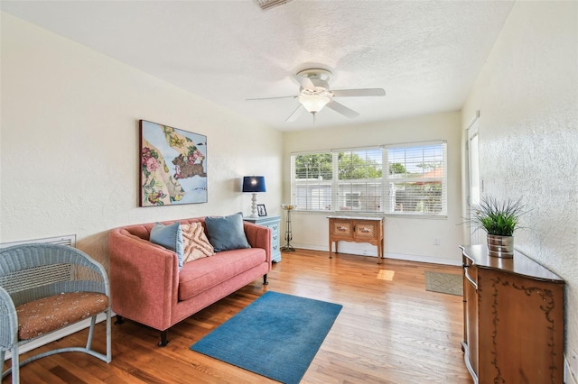 4211 28th Ave N, Saint Petersburg, FL 33713 - living area with wood finished floors, a textured wall, a ceiling fan, and a textured ceiling