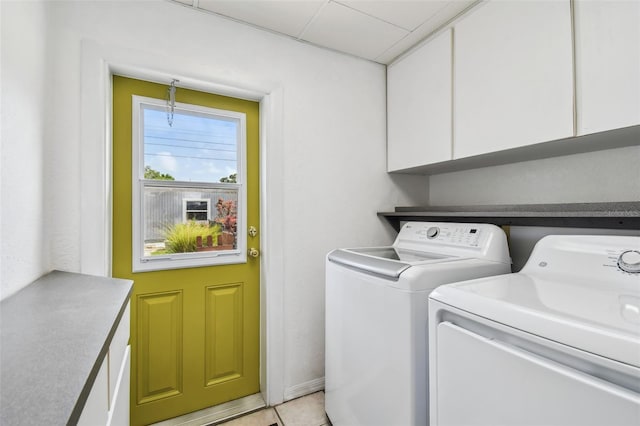 4211 28th Ave N, Saint Petersburg, FL 33713 - laundry area with cabinet space, washer and dryer, and light tile patterned floors