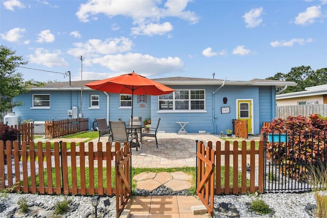 4211 28th Ave N, Saint Petersburg, FL 33713 - back of house featuring a fenced front yard, a patio area, and a gate