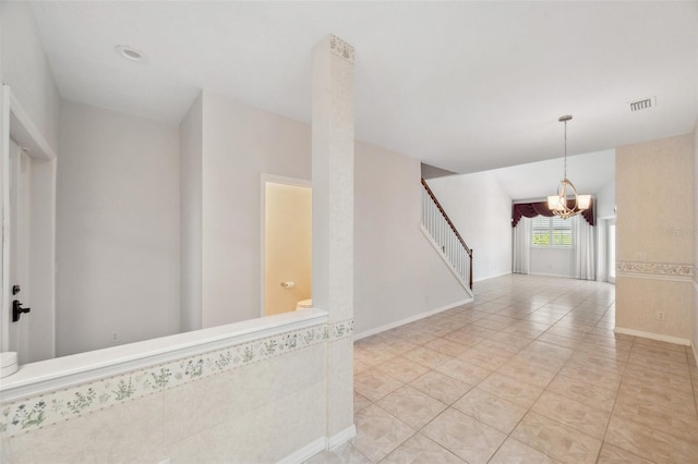 6400 46th Ave N Unit 61, Kenneth City, FL 33709 - spare room featuring a chandelier, stairway, and light tile patterned flooring
