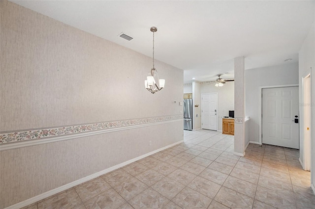 6400 46th Ave N Unit 61, Kenneth City, FL 33709 - spare room with a chandelier, a ceiling fan, wallpapered walls, and light tile patterned flooring