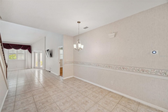 6400 46th Ave N Unit 61, Kenneth City, FL 33709 - unfurnished room featuring a chandelier and light tile patterned flooring