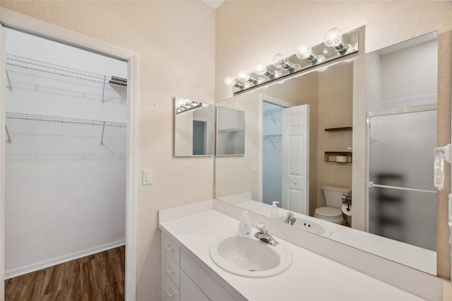 6400 46th Ave N Unit 61, Kenneth City, FL 33709 - full bath with wood finished floors, vanity, a shower stall, and a spacious closet