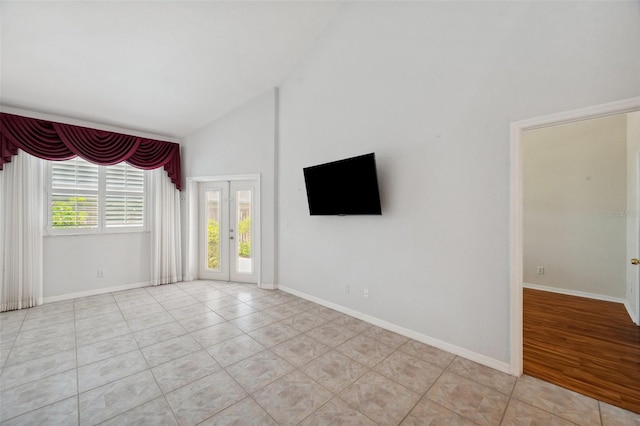 6400 46th Ave N Unit 61, Kenneth City, FL 33709 - empty room with high vaulted ceiling, light tile patterned flooring, and french doors