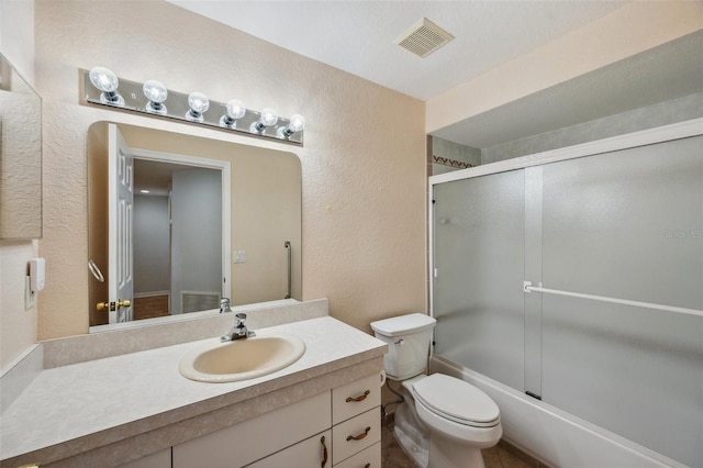 6400 46th Ave N Unit 61, Kenneth City, FL 33709 - bathroom with a textured wall, vanity, and combined bath / shower with glass door
