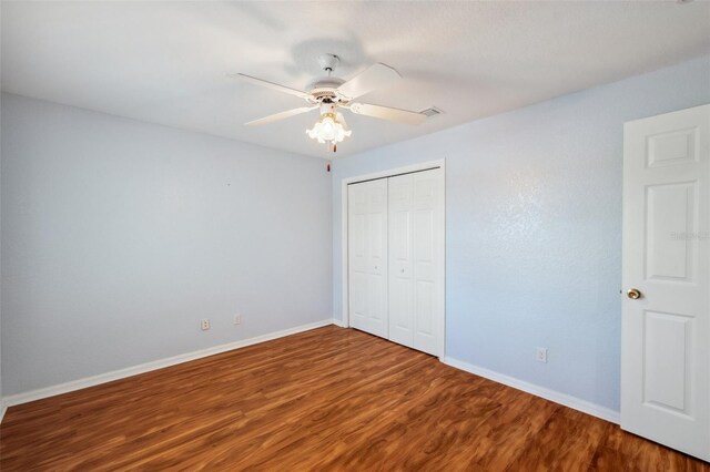 6400 46th Ave N Unit 61, Kenneth City, FL 33709 - unfurnished bedroom with wood finished floors, a closet, and ceiling fan
