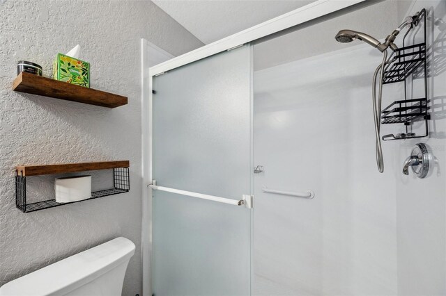 6400 46th Ave N Unit 61, Kenneth City, FL 33709 - bathroom with a shower stall and a textured wall