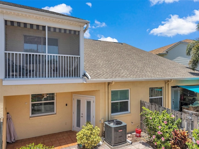 6400 46th Ave N Unit 61, Kenneth City, FL 33709 - back of property with stucco siding, a shingled roof, french doors, and a patio area