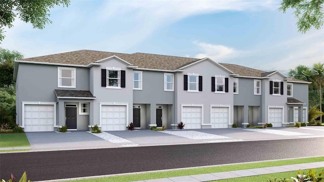 135 Mangrove Shade Cir, Apollo Beach, FL 33572 - townhome / multi-family property featuring an attached garage, stucco siding, driveway, and a shingled roof