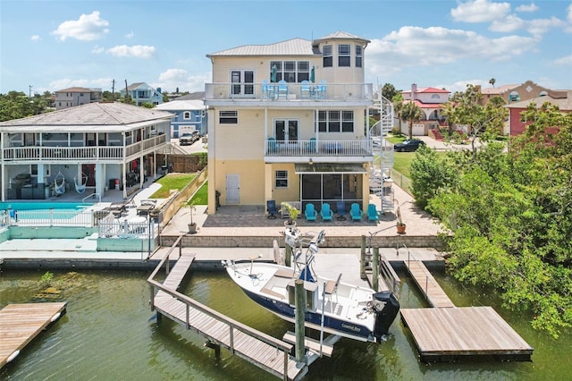 6543 Louise Ct, Hudson, FL 34667 - rear view of property with a balcony, a water view, a patio area, and a fenced backyard